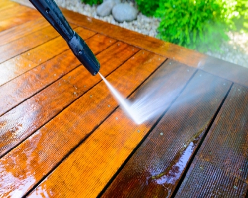 Timber decking being pressure washed clean